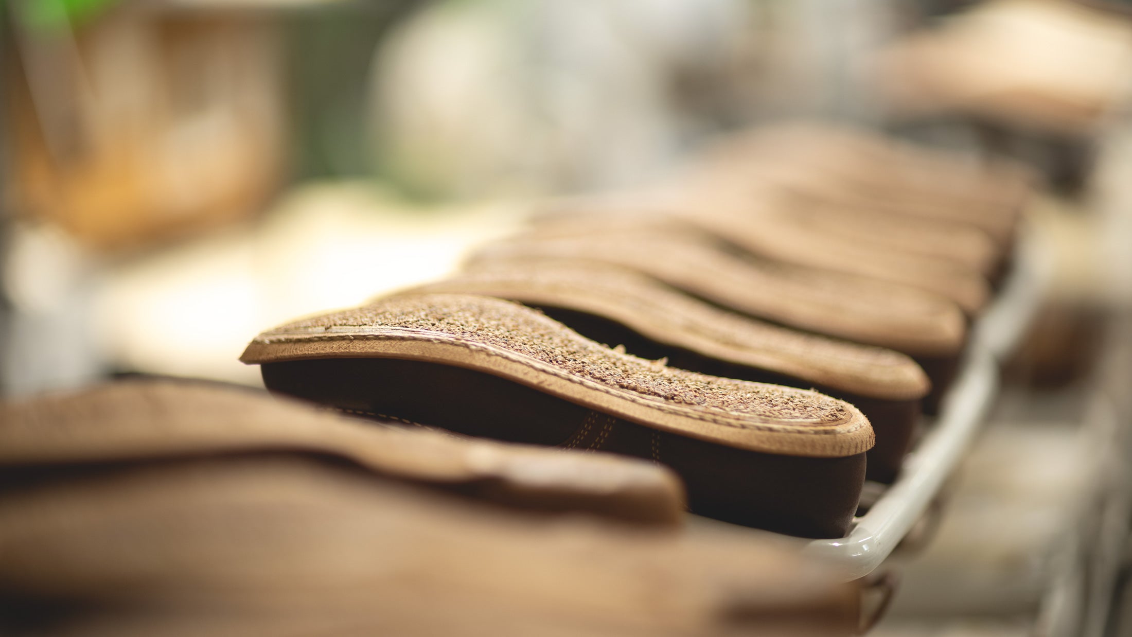  boots upside down on racks in production filled with cork