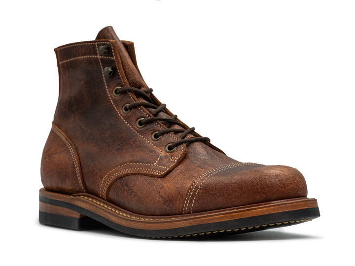 3qtr view of brown textured leather boot on white background