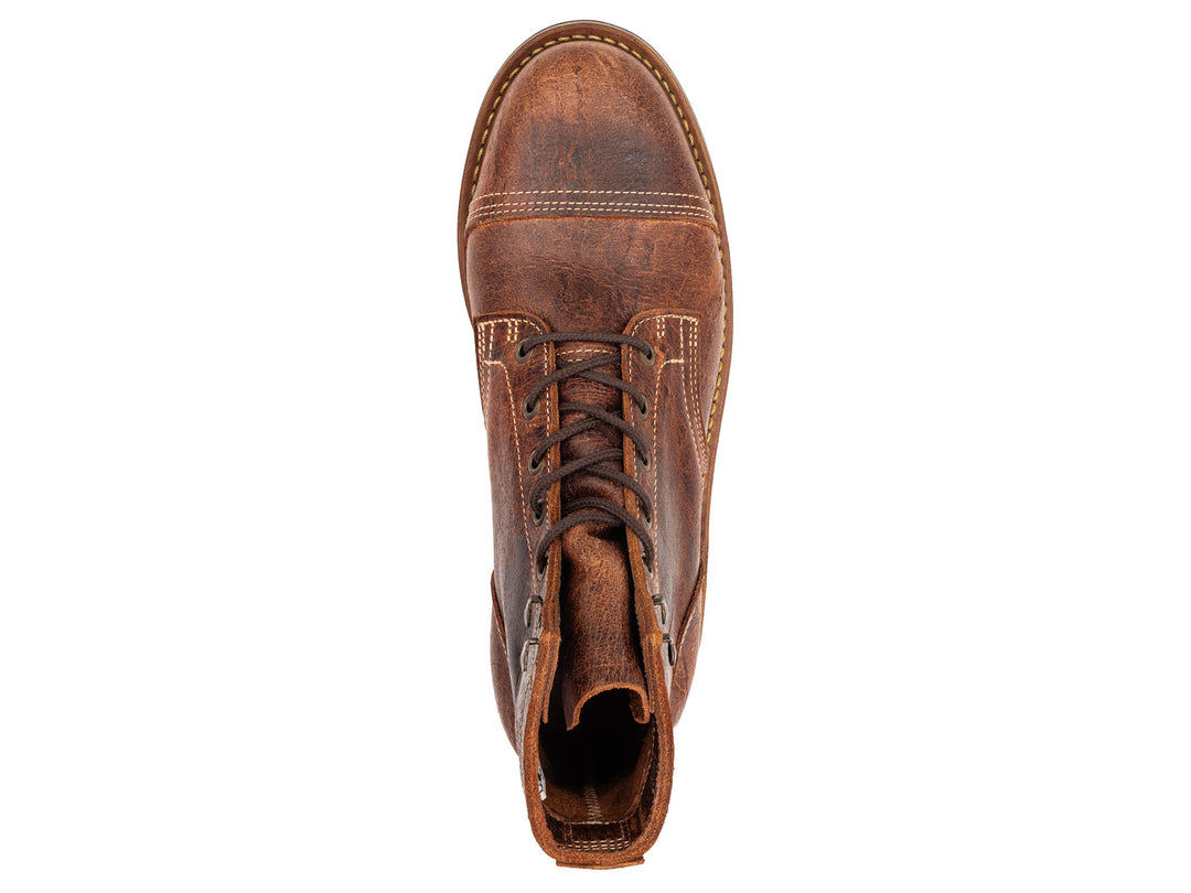 topdown view of brown textured leather boot on white background