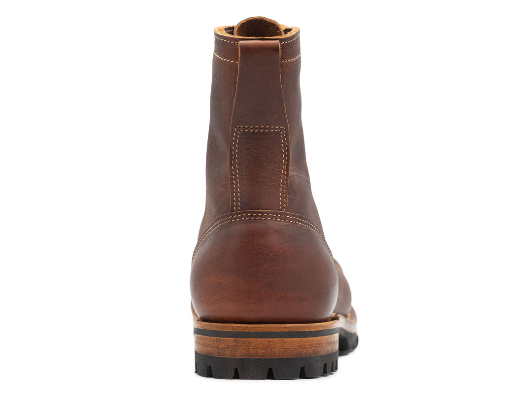 auburn brown leather boot on a white background view from behind