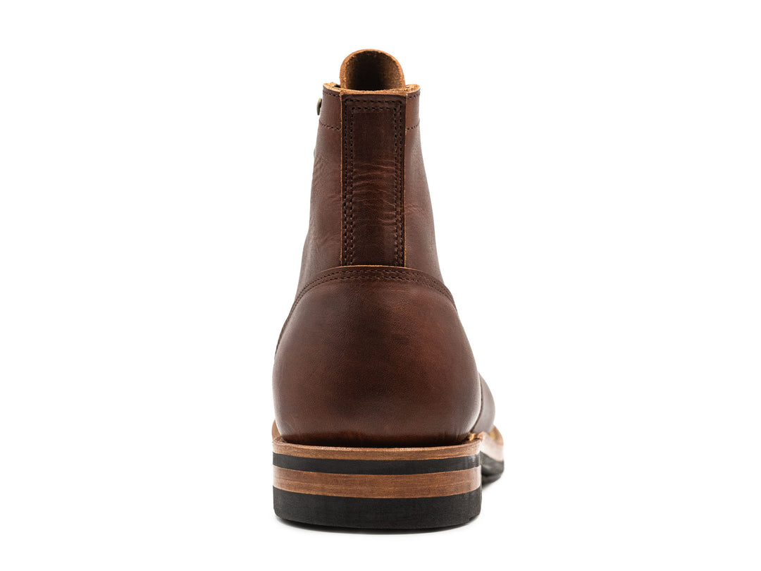 brown leather boot on a white background view from behind