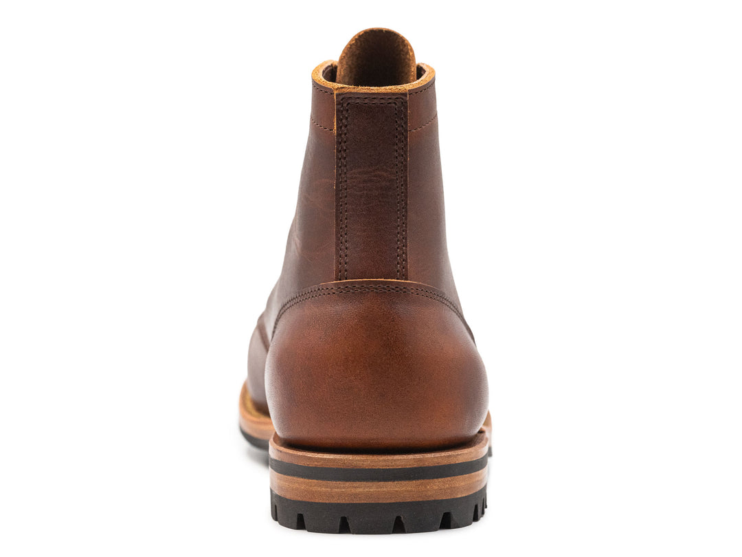 auburn brown leather boot on a white background view from behind