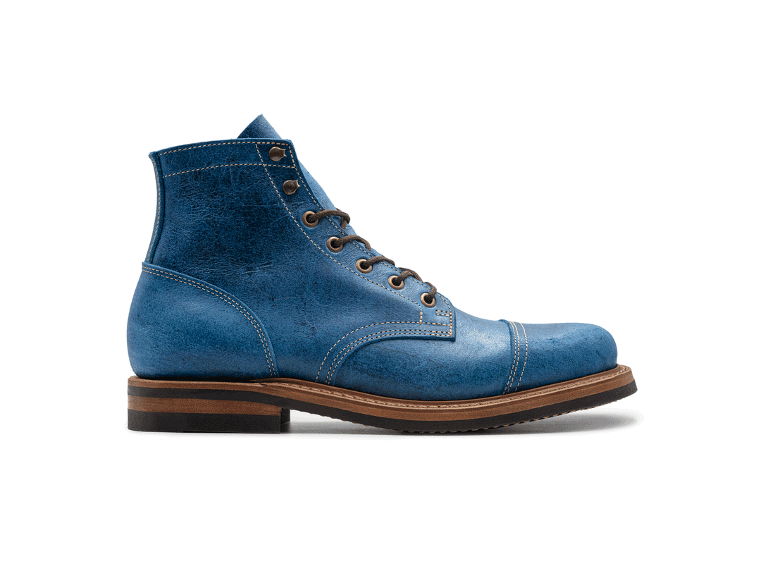 rotating 360° view of blue textured leather boot on white background