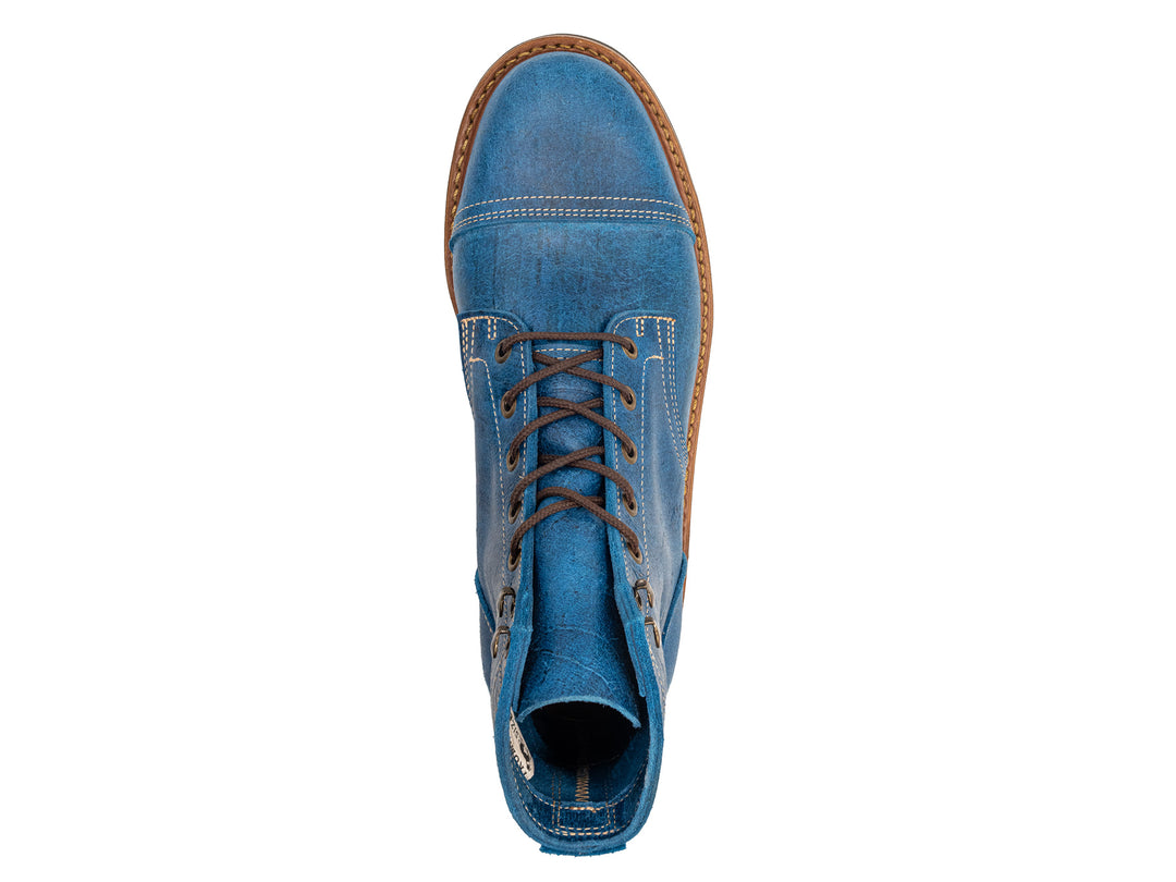 topdown view of blue textured leather boot on white background