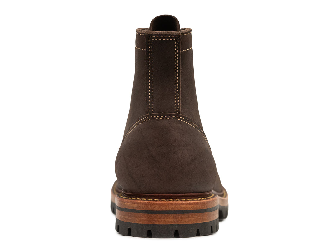 back view of brown textured kudu leather boot on white background