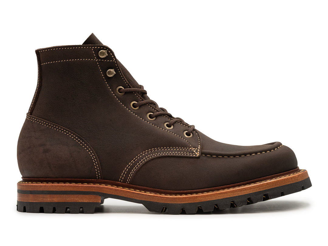 side view of brown textured kudu leather boot on white background