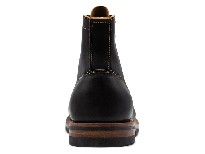 back view of black leather boot on white background