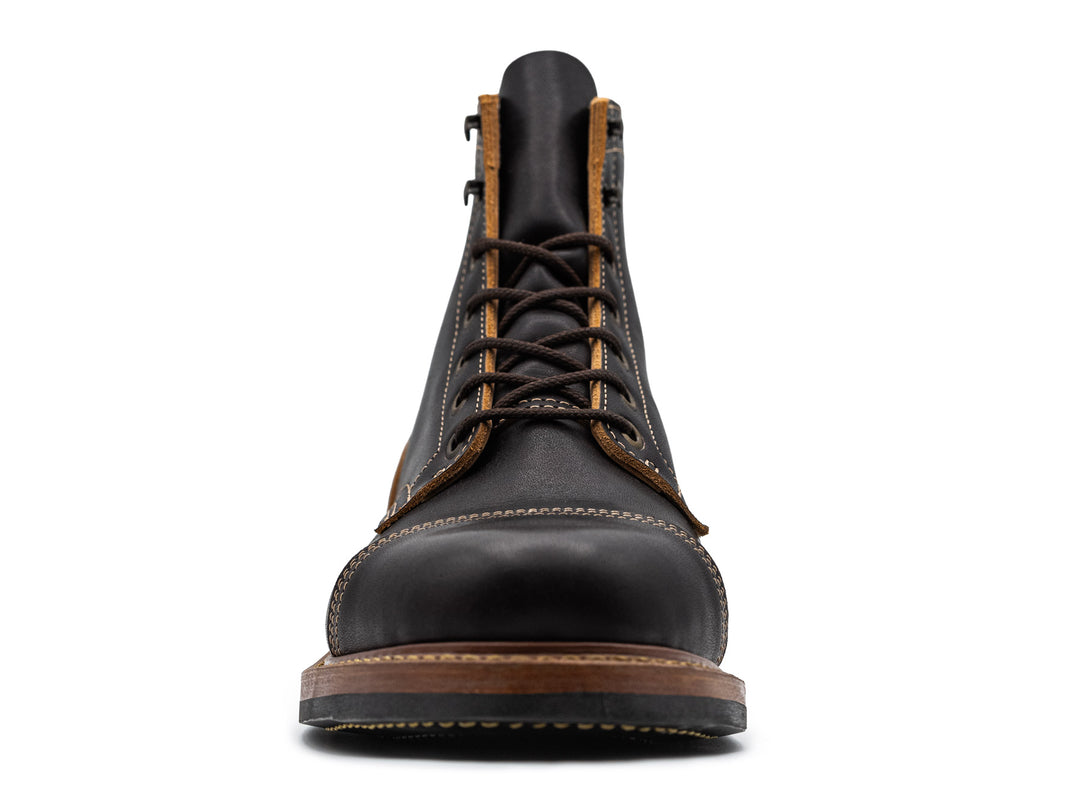 front view of black leather boot on white background