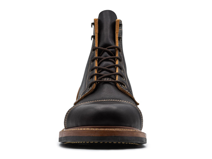 front view of black leather boot on white background