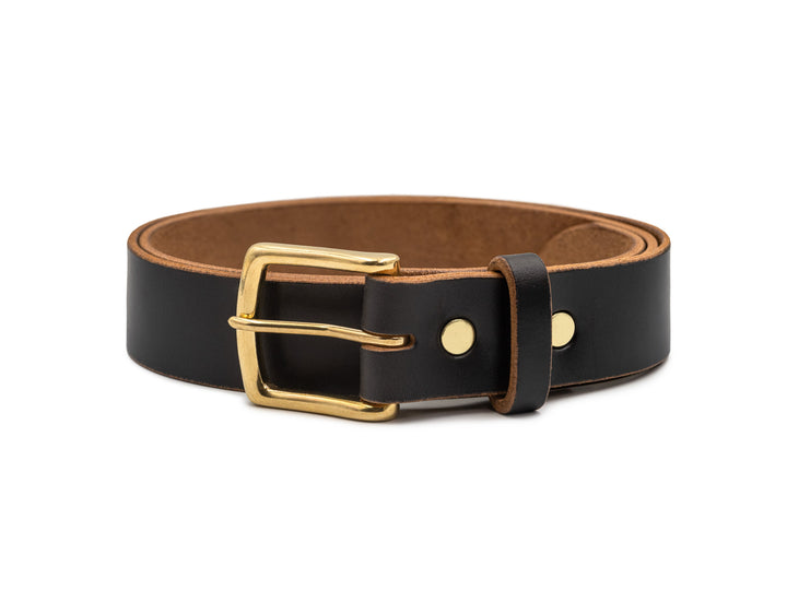 black leather belt with brass buckle, coiled on white background