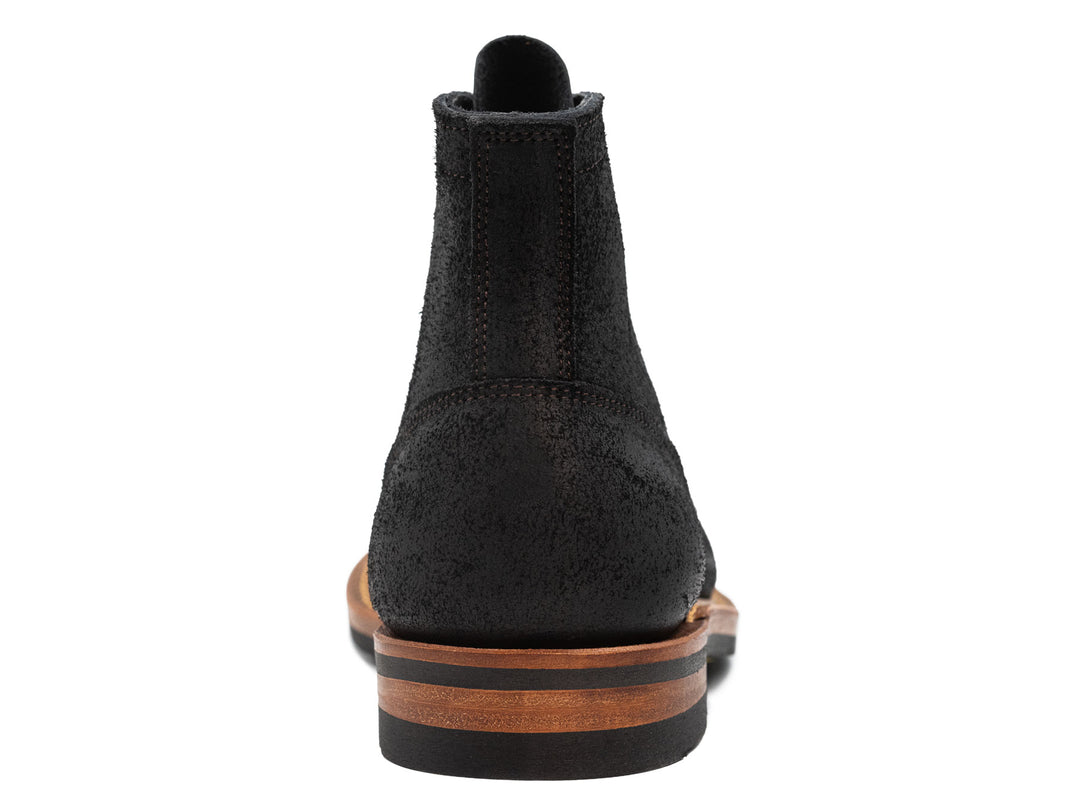 back view of black oiled rough out leather boot on white background