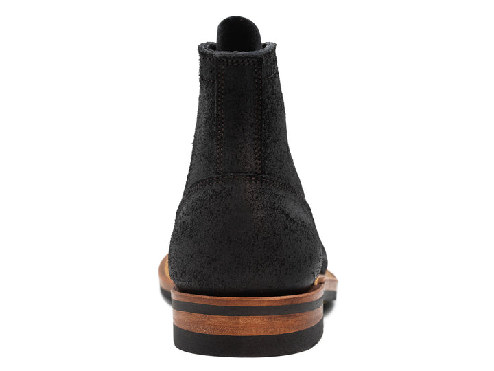 back view of black oiled rough out leather boot on white background