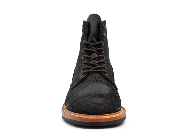 front view of black oiled rough out leather boot on white background