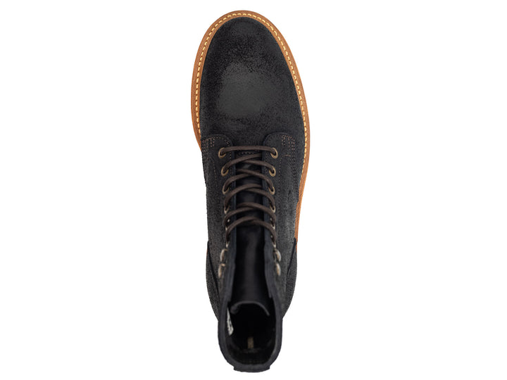 topdown view of black oiled rough out leather boot on white background