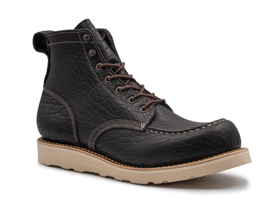 three-quarter view black shrunken bison boot on wedge sole on white background