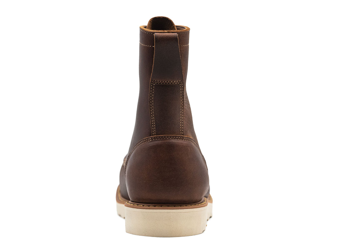 brown leather moc toe boot on a white background view from behind