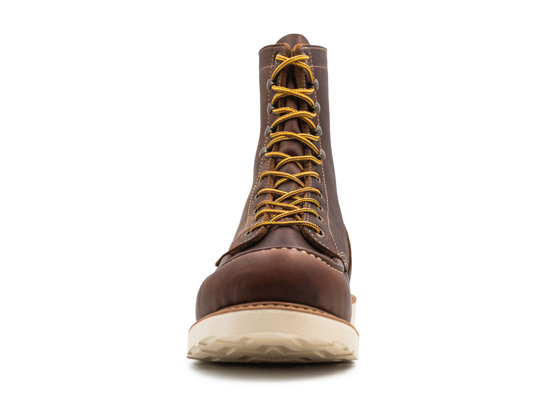 brown leather moc toe boot on a white background front view