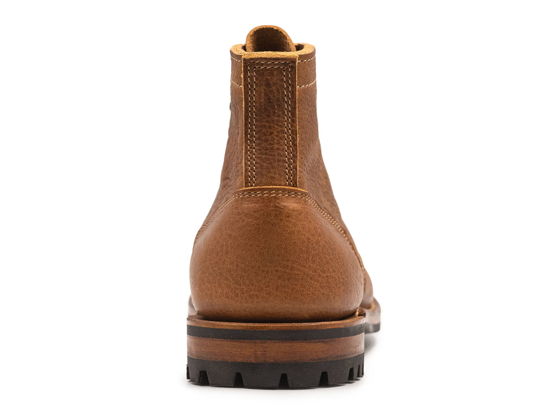 tan leather boot on a white background view from behind