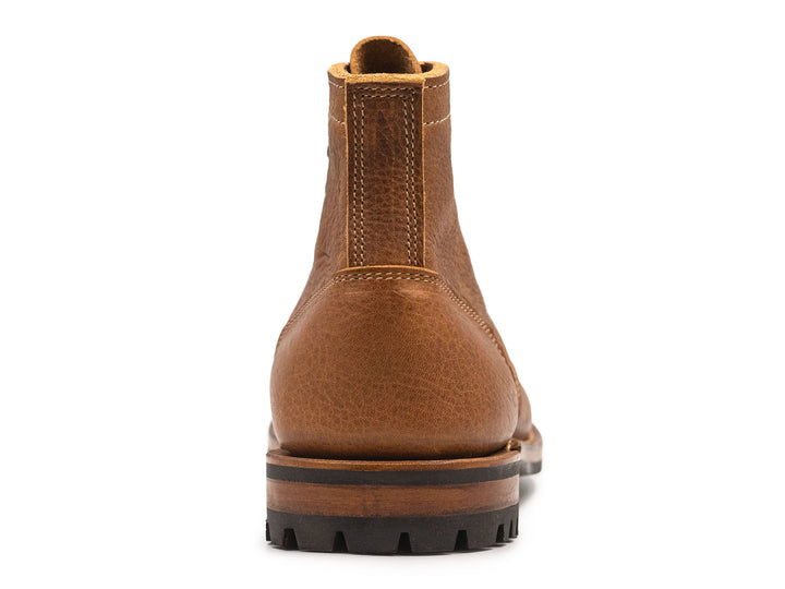 tan leather boot on a white background view from behind