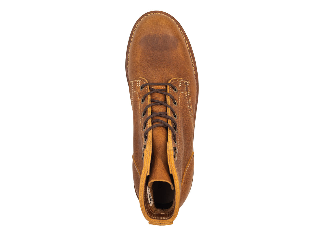 tan leather boot on a white background topdown view