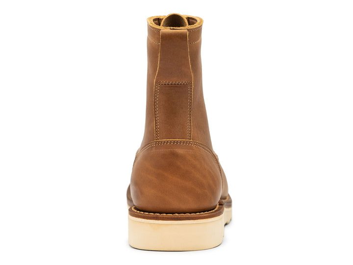 tan leather boot on a white background view from behind