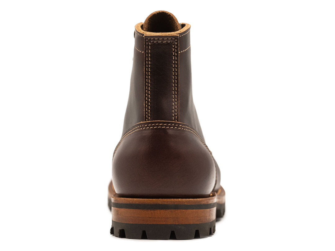 dark brown leather boot on a white background view from behind