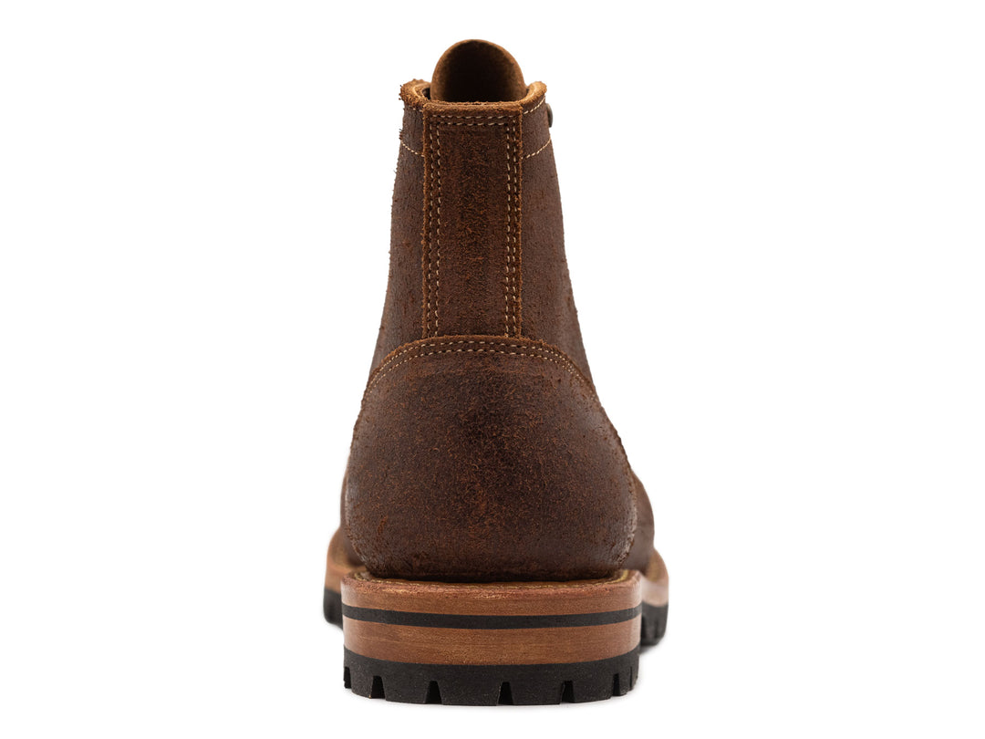 dark brown rough out leather boot view from behind on white
