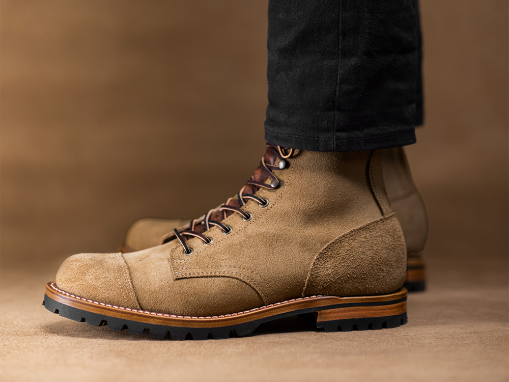 worn tan boots on tan leather background