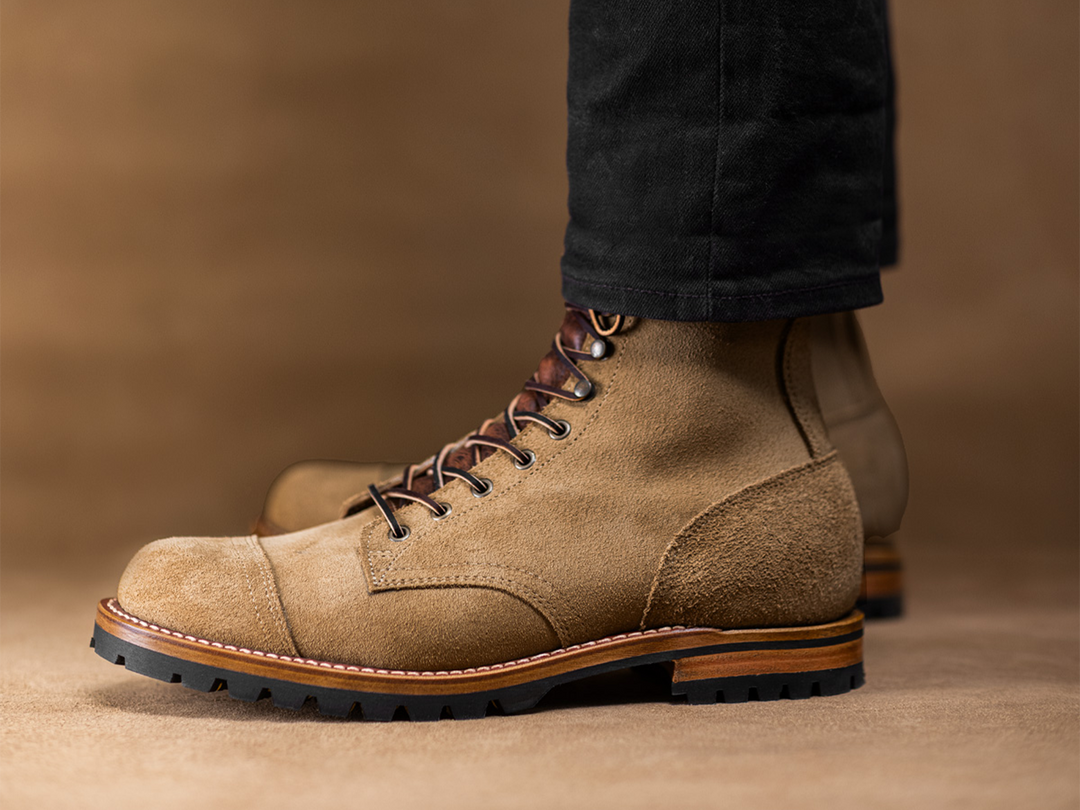 worn tan boots on tan leather background