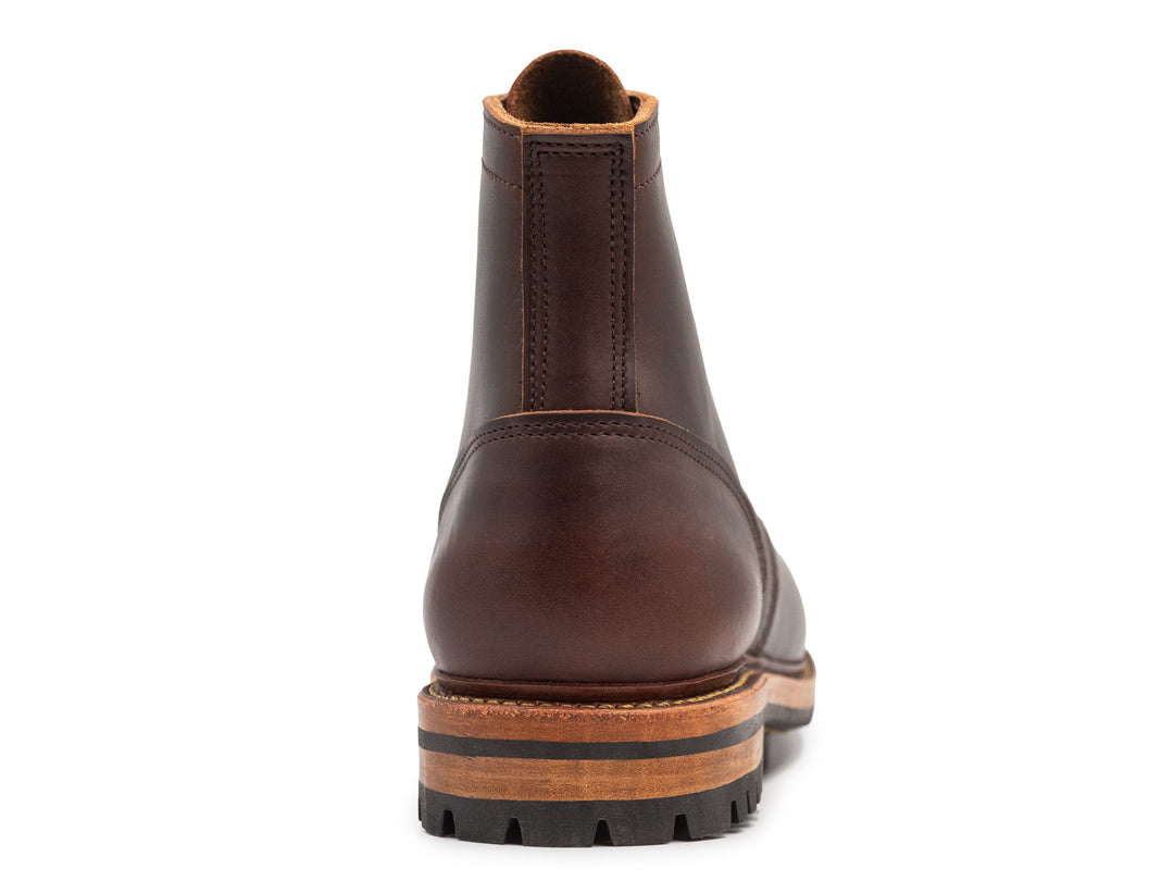 rear view of brown smooth leather boot on white background