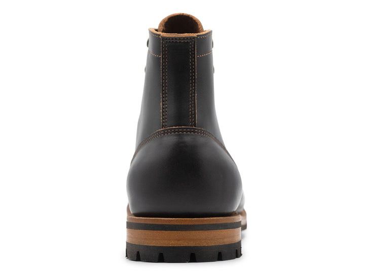 black leather boot on a white background view from behind