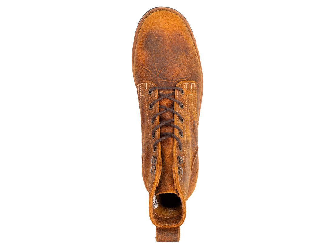 topdown view of brown orange textured leather boot on white background