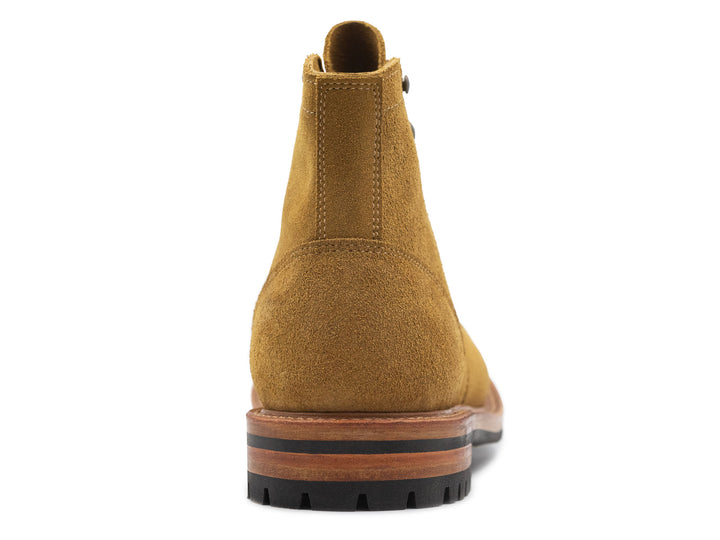 tan leather boot on a white background view from behind