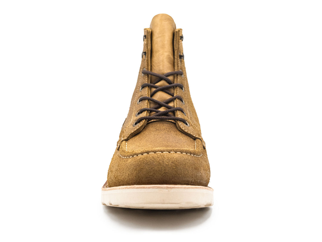 tan rough out leather moc toe boot on a white background front view