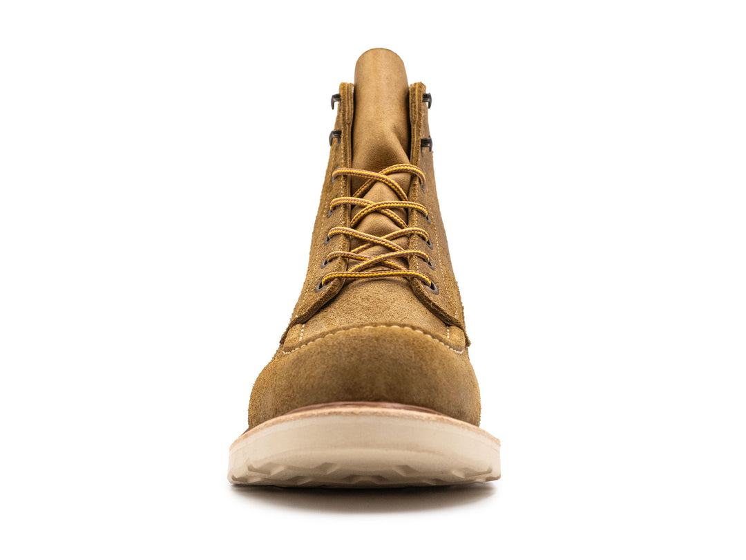 tan leather moc toe boot with yellow laces on a white background front view