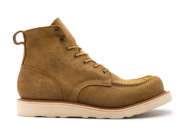 tan leather moc toe boot with yellow laces on a white background side view