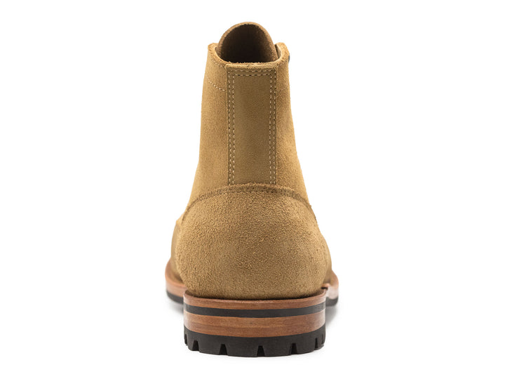 tan leather boot on a white background view from behind