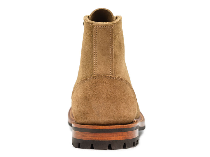 tan leather boot on a white background view from behind