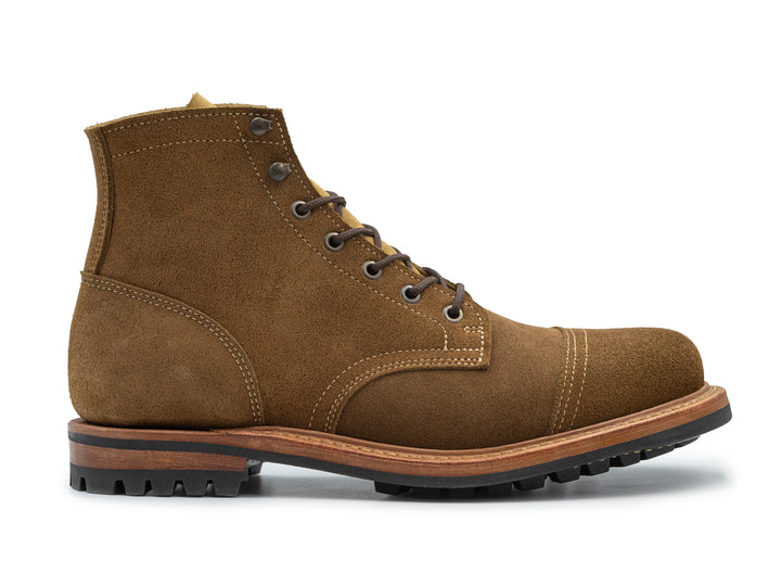 dark tan colored leather boot side view on white background