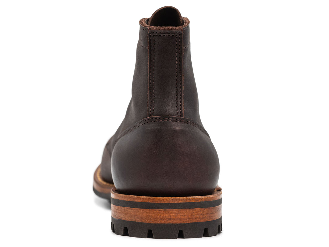 dark brown leather boot on a white background view from behind
