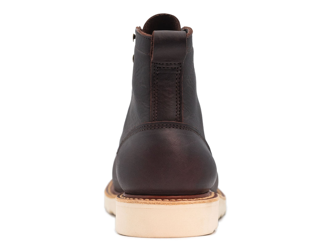 dark brown leather boot on a white background view from behind