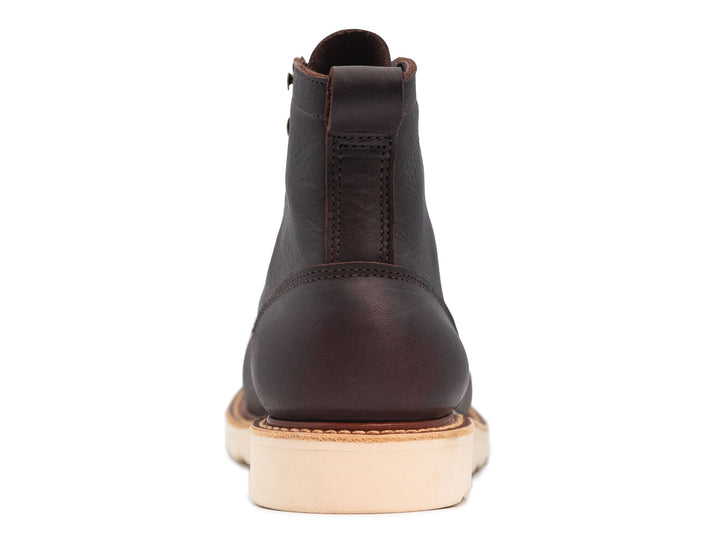 dark brown leather boot on a white background view from behind