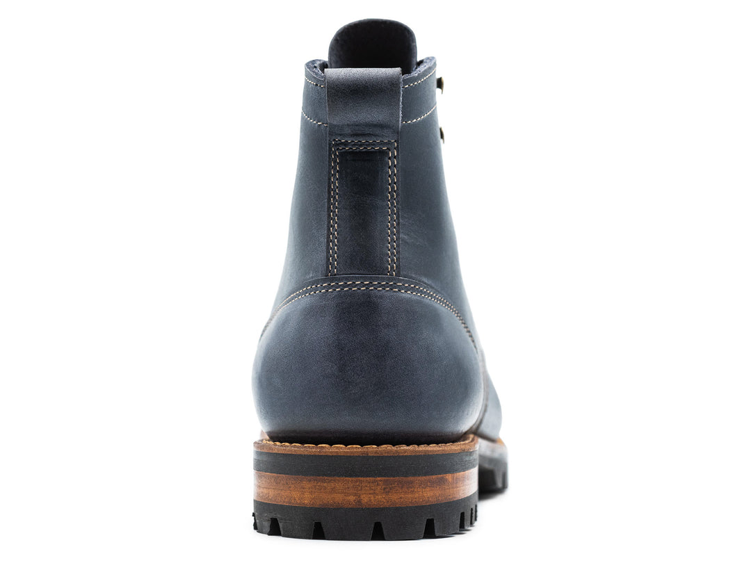 blue leather boot on a white background view from behind