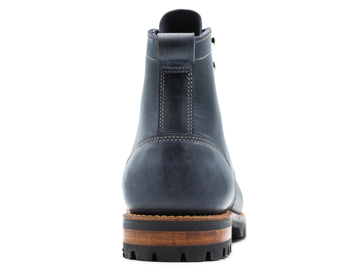 blue leather boot on a white background view from behind