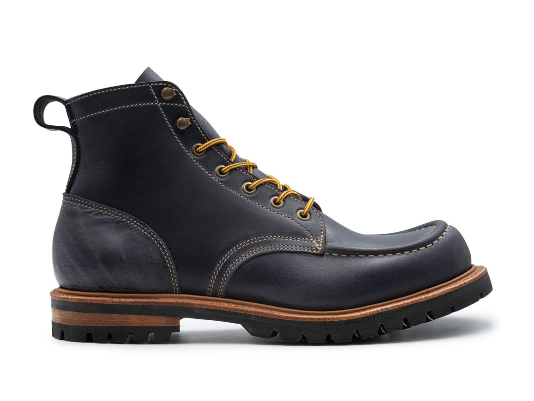 dark blue leather boot on white background