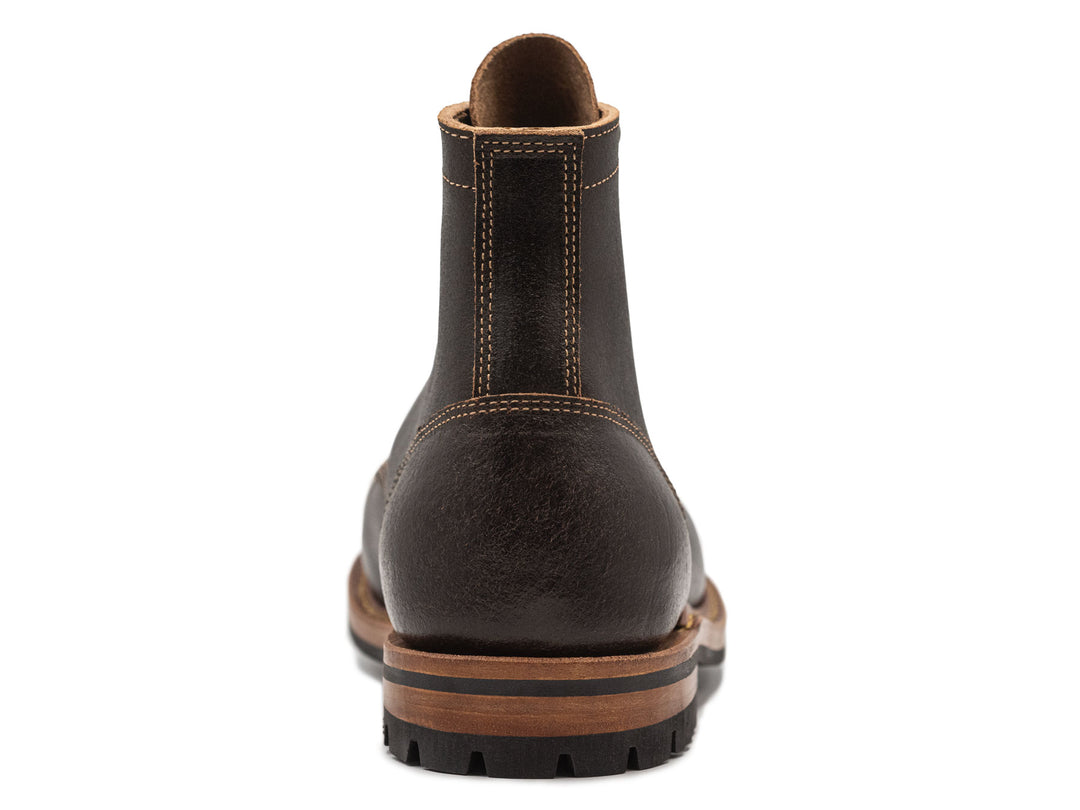 dark brown leather boot on a white background view from behind