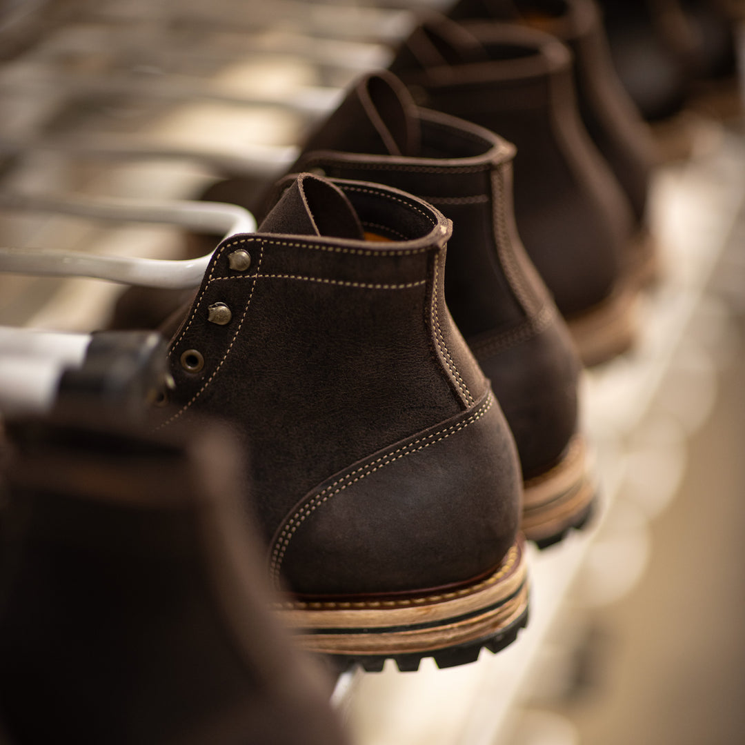line of kudu boots on rolling rack with shallow depth of field
