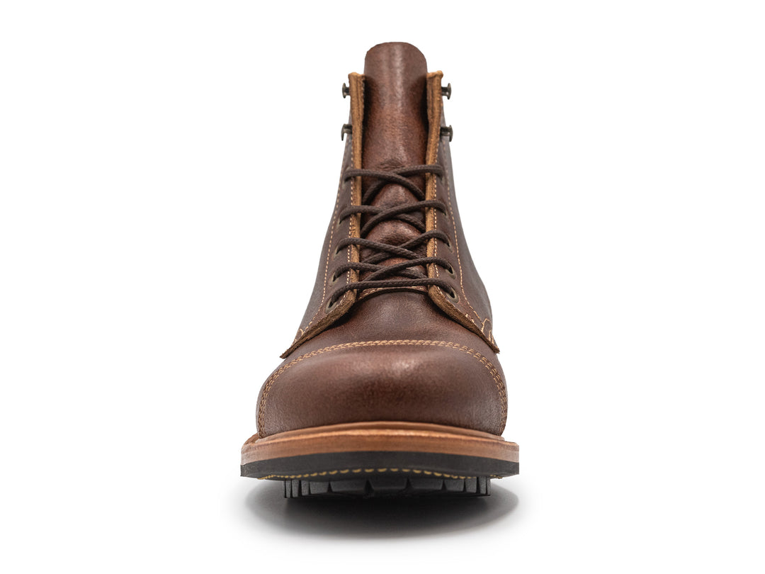 brown leather cap toe boot on a white background front view