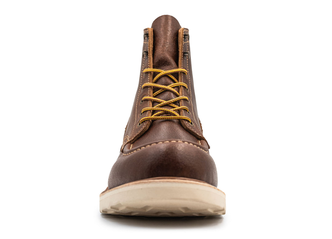 Brown leather moc toe boot with yellow laces on a white background front view