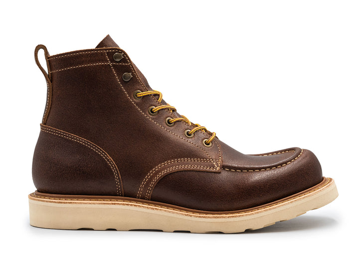 Brown leather moc toe boot with yellow laces on a white background side view